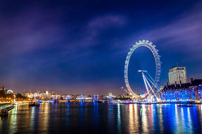 River with illuminated buildings in distance