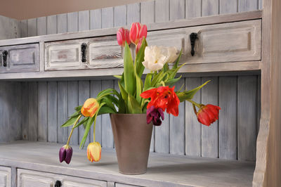 Tulips in vase on table at home