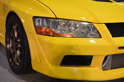 Close-up of yellow car parked on street