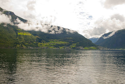 Scenic view of lake and mountains against sky