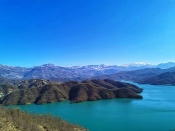 Scenic view of mountains against clear blue sky