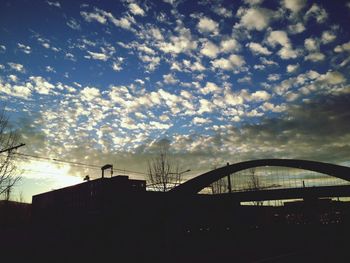 Low angle view of buildings against sky at sunset