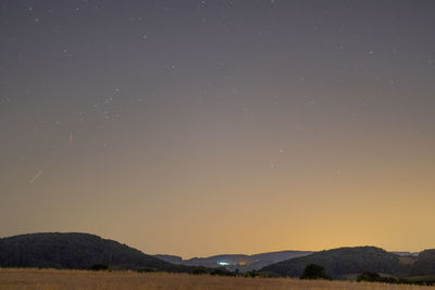 Scenic view of mountains against sky at night