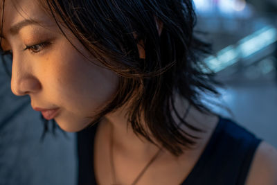 Close-up of young woman looking away