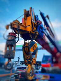 Close-up of machinery at construction site against sky