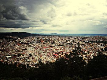 Cityscape against cloudy sky