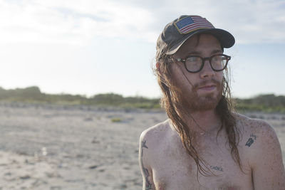 Portrait of young man wearing sunglasses on beach