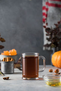 Delicious aromatic warming tea in a glass mug. autumn still life