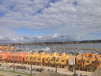 High angle view of buildings by sea against sky