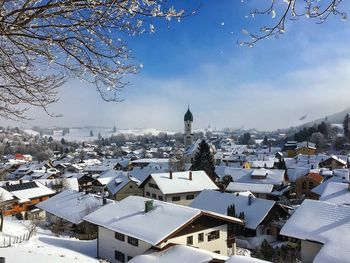 Houses in town against clear sky during winter