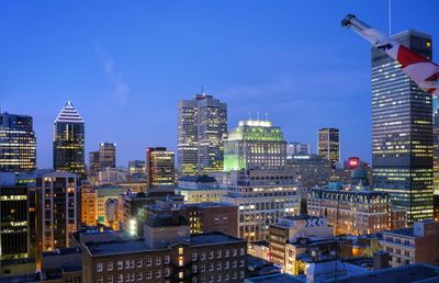 Illuminated cityscape against sky