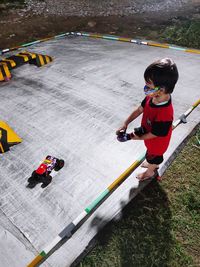 High angle view of boy playing with umbrella