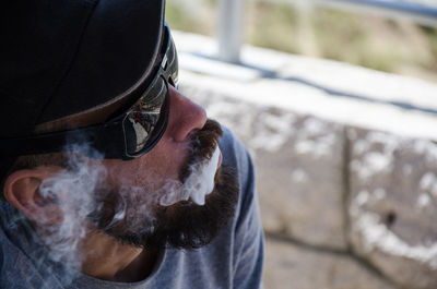 High angle view of man smoking while wearing sunglasses