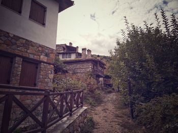 Steps leading towards old building against sky