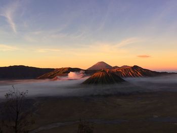 Scenic view of mountains against cloudy sky