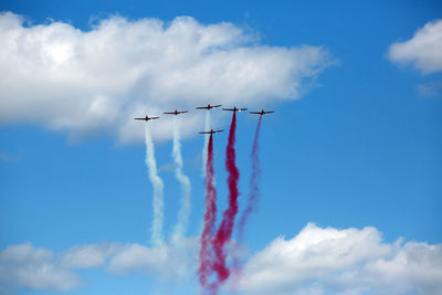 Low angle view of airshow against sky