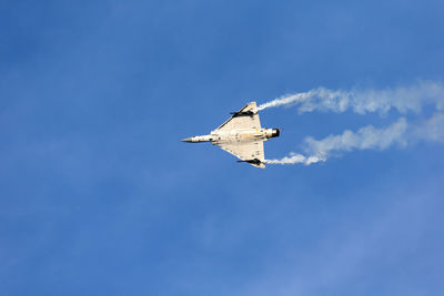 Low angle view of airplane flying in sky