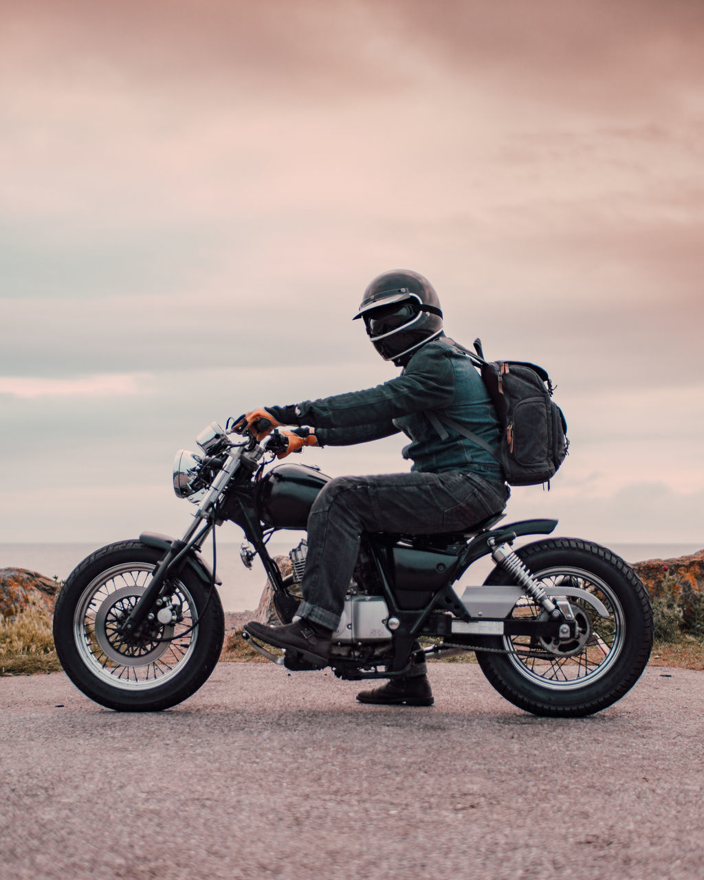 MAN RIDING BICYCLE ON MOTORCYCLE