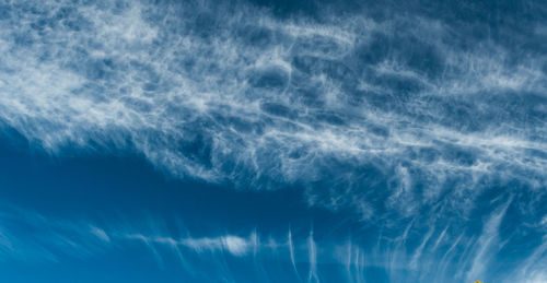 Aerial view of vapor trails in blue sky