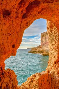 Scenic view of sea seen through cave