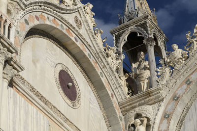 Low angle view of statue against historic building