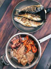 High angle view of meat on barbecue grill