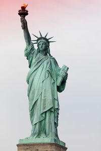 Low angle view of statue of liberty against sky