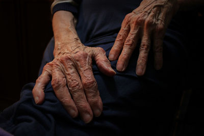 Close-up of woman hands against black background