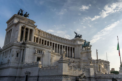 Low angle view of historical building against cloudy sky