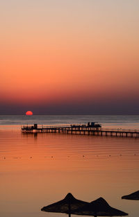 Scenic view of sea against clear sky during sunset