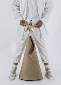 Man with christmas tree in eco style on white background. zero waste, eco friendly, provocation