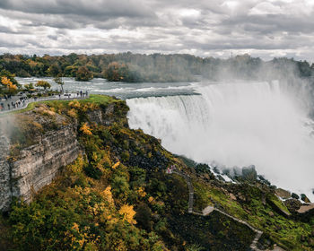 Scenic view of waterfall against sky