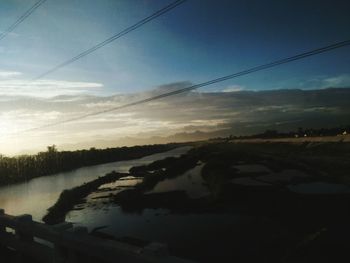 Scenic view of landscape against sky at sunset