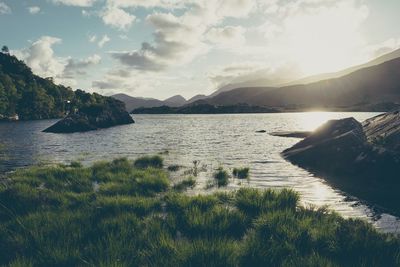 Scenic view of lake against cloudy sky
