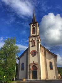 Low angle view of clock tower against sky