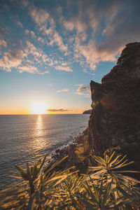 Sunset on shore of atlantic ocean and rocks at ponta do sol on the island of madeira, portugal. 