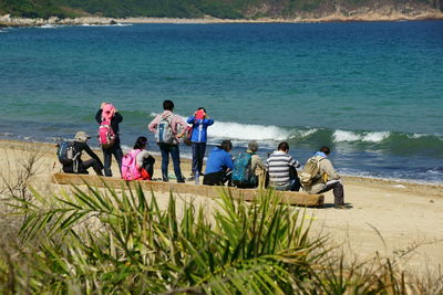 Rear view of people at beach