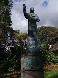 Low angle view of statue against trees