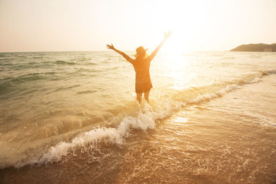 Woman at beach during sunset