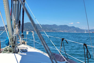 Sailboat sailing on sea against clear sky