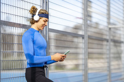 Side view of woman using mobile phone