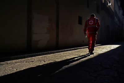 Rear view of man walking on street