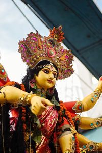 Portrait of young woman standing against christmas tree