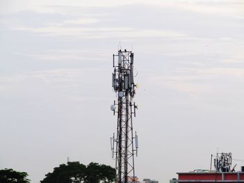 Low angle view of communications tower against sky