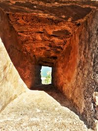 View of cave through tunnel