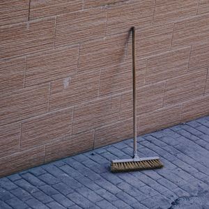 Old wooden broom abandoned in the street