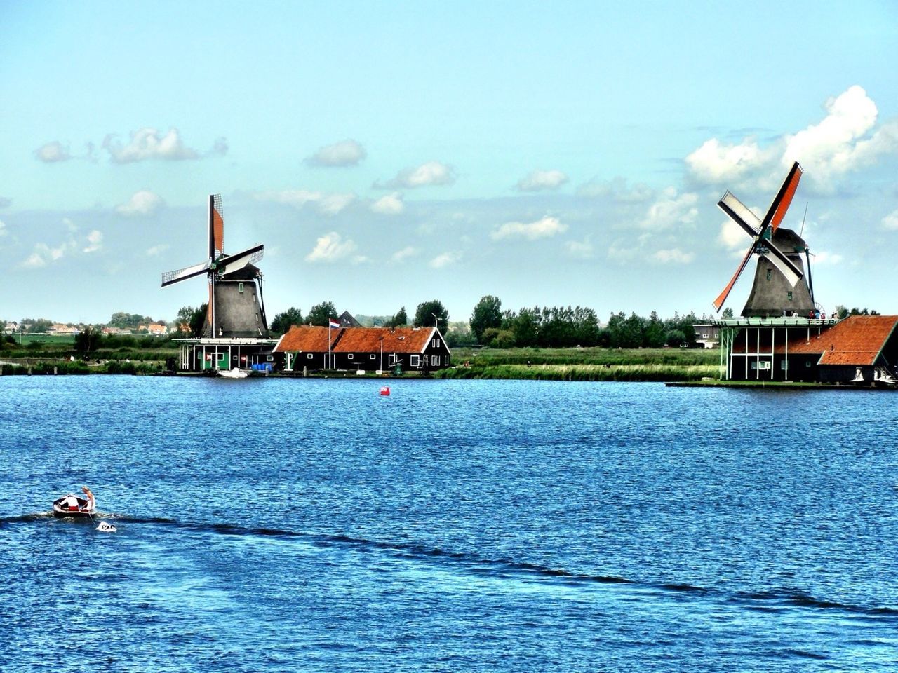 water, waterfront, architecture, built structure, building exterior, nautical vessel, sky, transportation, mode of transport, sea, cloud - sky, lake, boat, river, nature, scenics, lighthouse, tranquil scene, rippled, beauty in nature