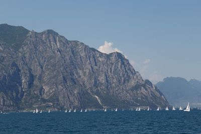 Scenic view of sea and mountains against sky