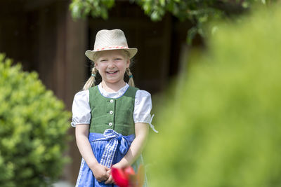 Portrait of girl smiling while standing outdoors