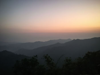Scenic view of silhouette mountains against sky during sunset